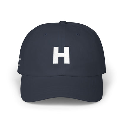 Navy blue cap with a white 'H' logo on a white background